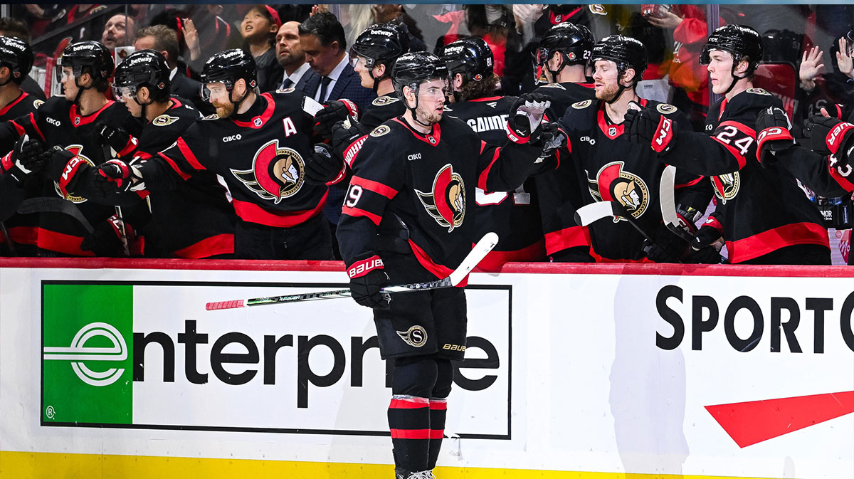 Ottawa Senators right wing Drake Batherson (19) celebrates his goal against the Calgary Flames with his teammates at the bench during the second period at Canadian Tire Centre.