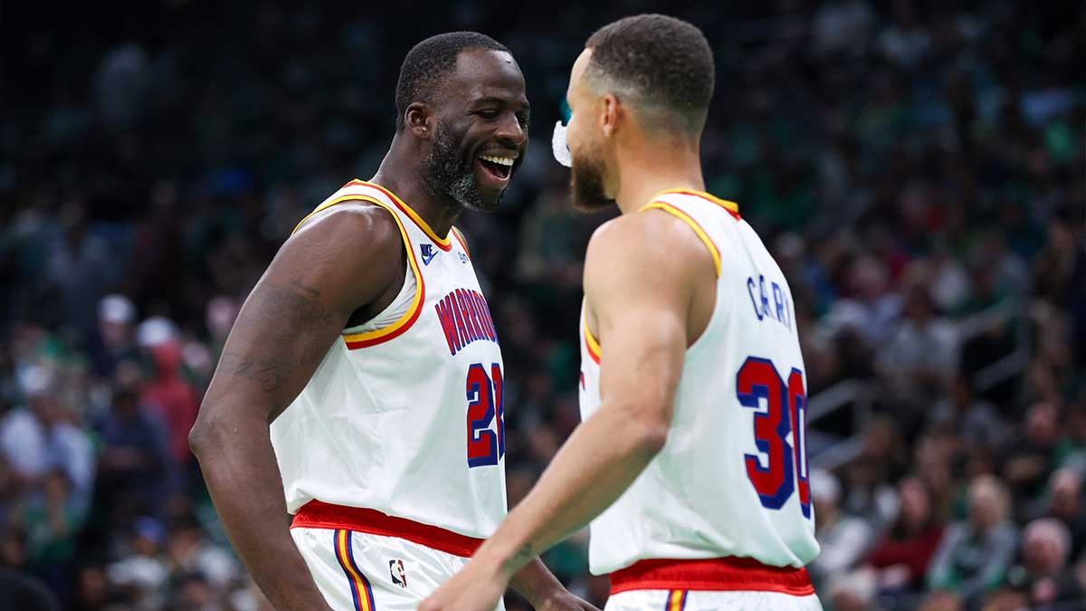 Golden State Warriors forward Draymond Green (23) and Golden State Warriors guard Stephen Curry (30) celebrate during the first half against the Boston Celtics at TD Garden.