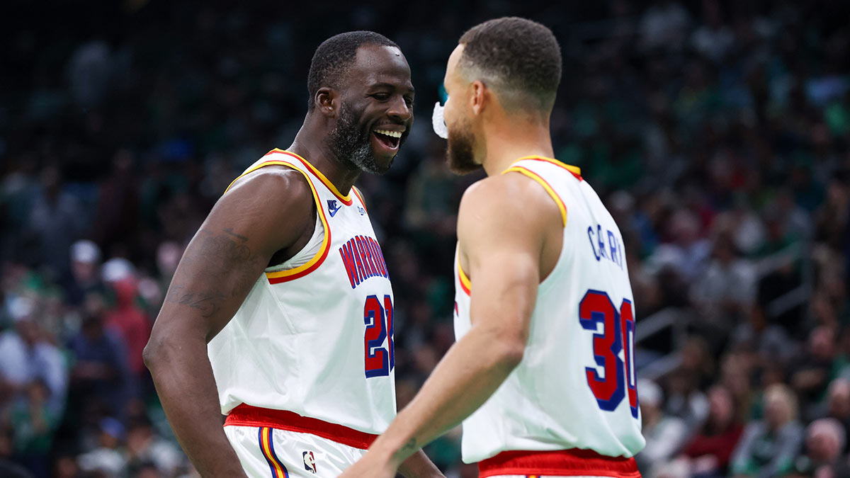 Golden State Warriors forward Draymond Green (23) and Golden State Warriors guard Stephen Curry (30) celebrate during the first half against the Boston Celtics at TD Garden. 