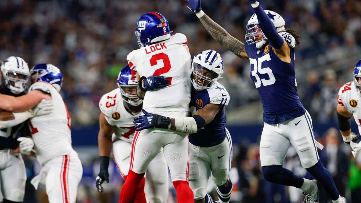 Nov 28, 2024; Arlington, Texas, USA; New York Giants quarterback Drew Lock (2) is sacked by Dallas Cowboys linebacker Micah Parsons (11) during the third quarter at AT&T Stadium.