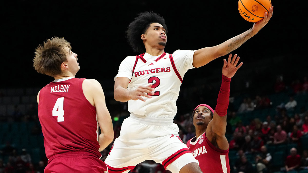 Rutgers Scarlet Knights guard Dylan Harper (2) shoots between Alabama Crimson Tide forward Grant Nelson (4) and Alabama Crimson Tide forward Jarin Stevenson (15) during the first half at MGM Grand Garden Arena.