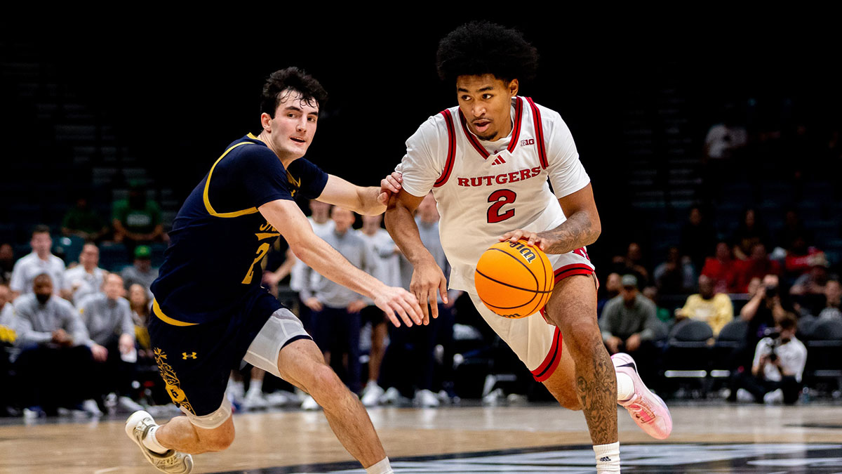 Rutgers Scarlet Knights guard Dylan Harper (2) drives past Notre Dame Fighting Irish guard Logan Imes during overtime at MGM Grand Garden Arena.