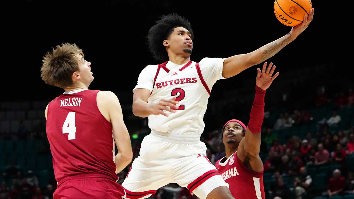 Rutgers Scarlet Knights guard Dylan Harper (2) shoots between Alabama Crimson Tide forward Grant Nelson (4) and Alabama Crimson Tide forward Jarin Stevenson (15) during the first half at MGM Grand Garden Arena.