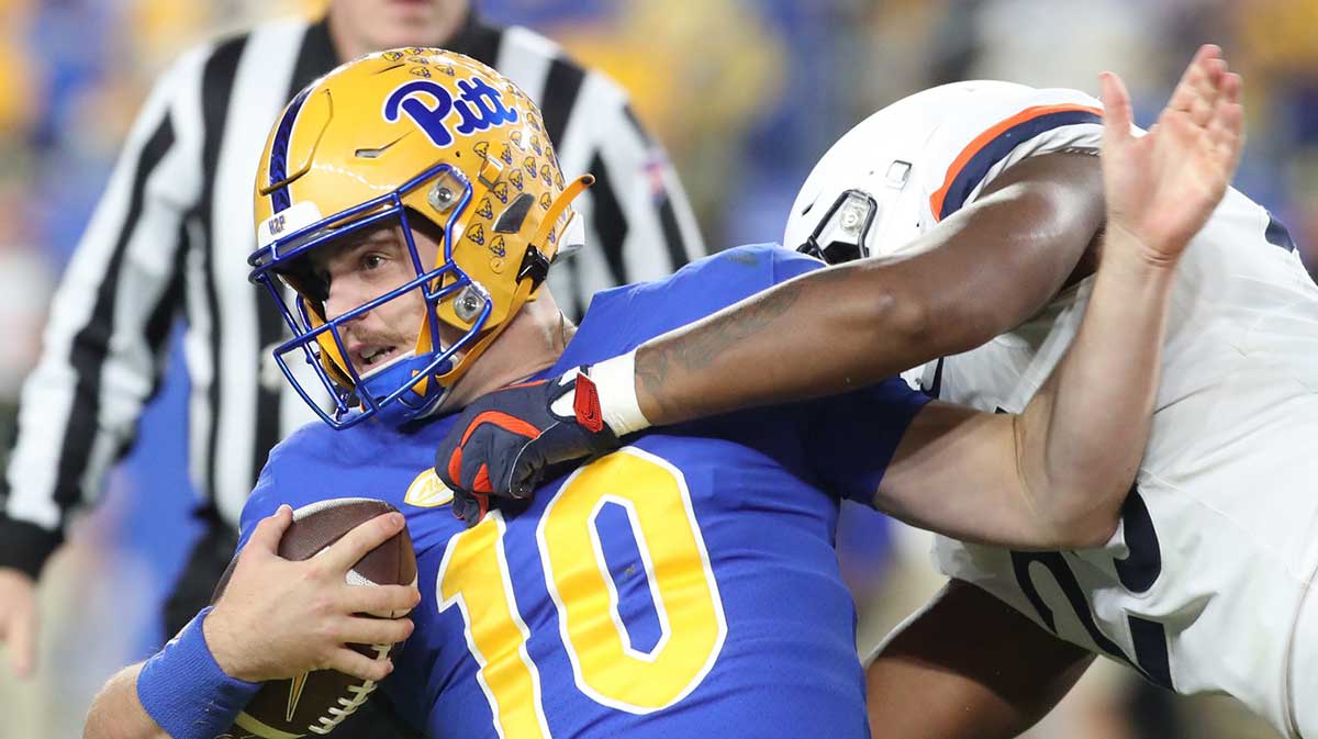 Pittsburgh Panthers quarterback Eli Holstein (10) is tackled by Virginia Cavaliers defensive tackle Terrell Jones (25) during the second quarter at Acrisure Stadium.