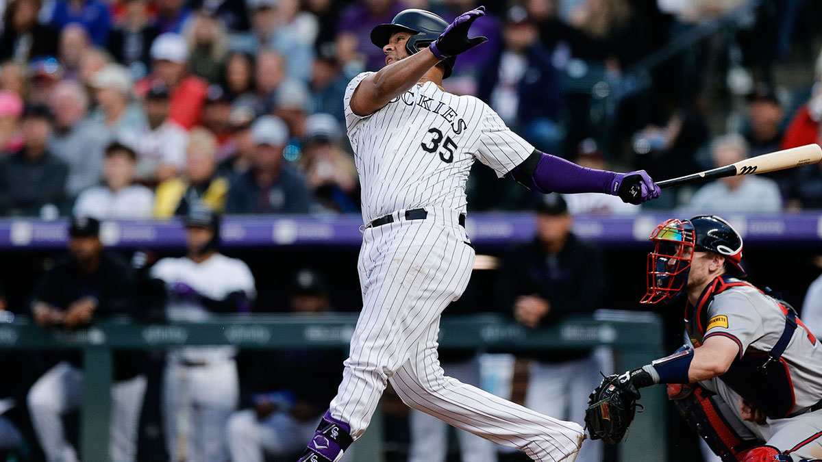 Colorado Rockies catcher Elias Diaz (35) hits an RBI double in the fourth inning against the Atlanta Braves at Coors Field.