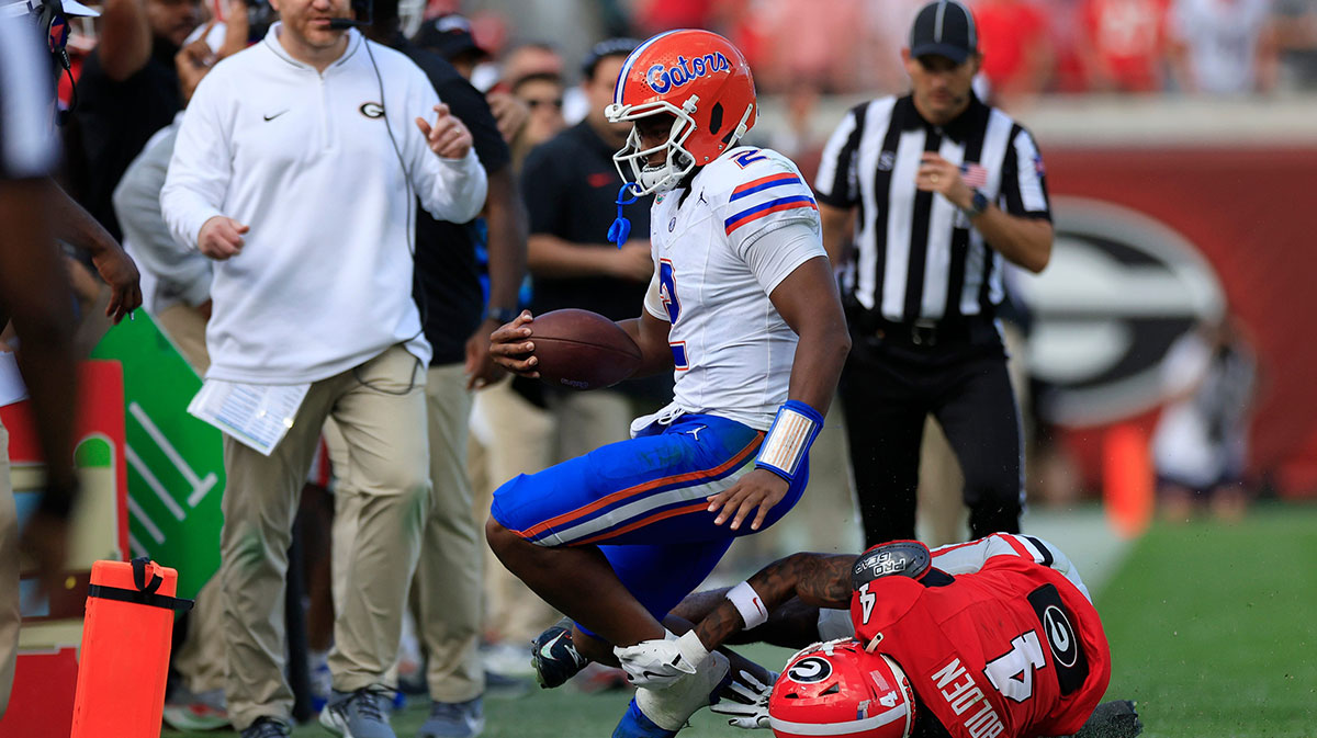 Florida Gators quarterback DJ Lagway (2) is shoved out of bounds by Georgia Bulldogs defensive back KJ Bolden (4) during the second quarter of an NCAA college football matchup Saturday, Nov. 2, 2024 at EverBank Stadium in Jacksonville, Fla. The Georgia Bulldogs defeated the Florida Gators 34-20. 