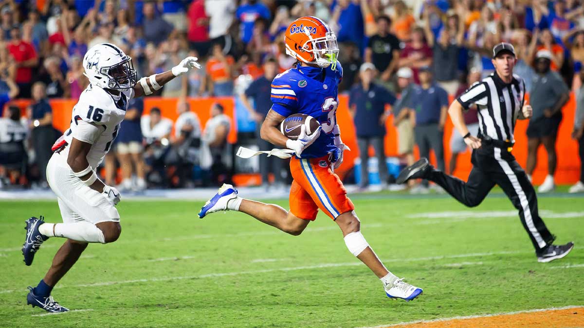 Florida Gators wide receiver Eugene Wilson III (3) runs for a touchdown as he looks back to Samford Bulldogs cornerback Kamron Smith (16) during the second half to make it 38-7 after the extra point at Ben Hill Griffin Stadium in Gainesville, FL on Saturday, September 7, 2024 against the Samford Bulldogs. The Florida Gators won 45-7 over the Bulldogs.