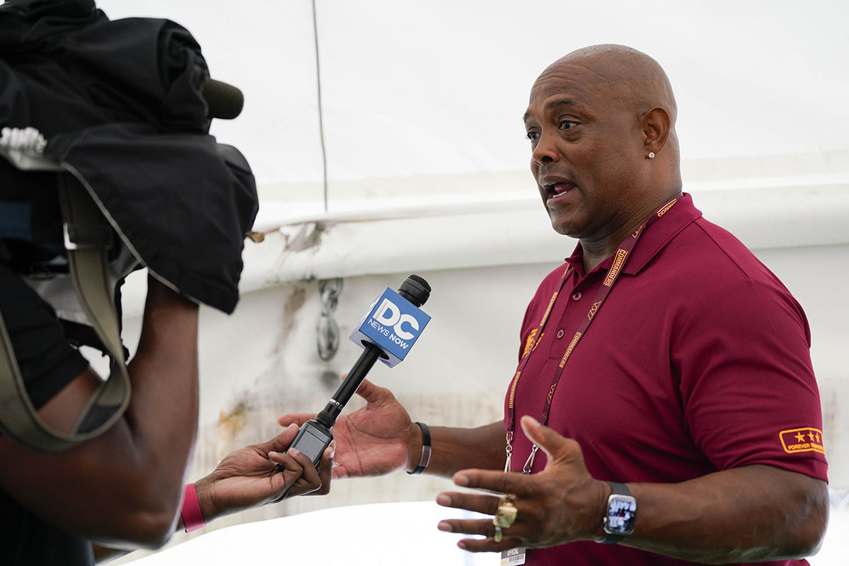 Former professional football player Brian Mitchell speaks to the media during a pregame event at FedExField.