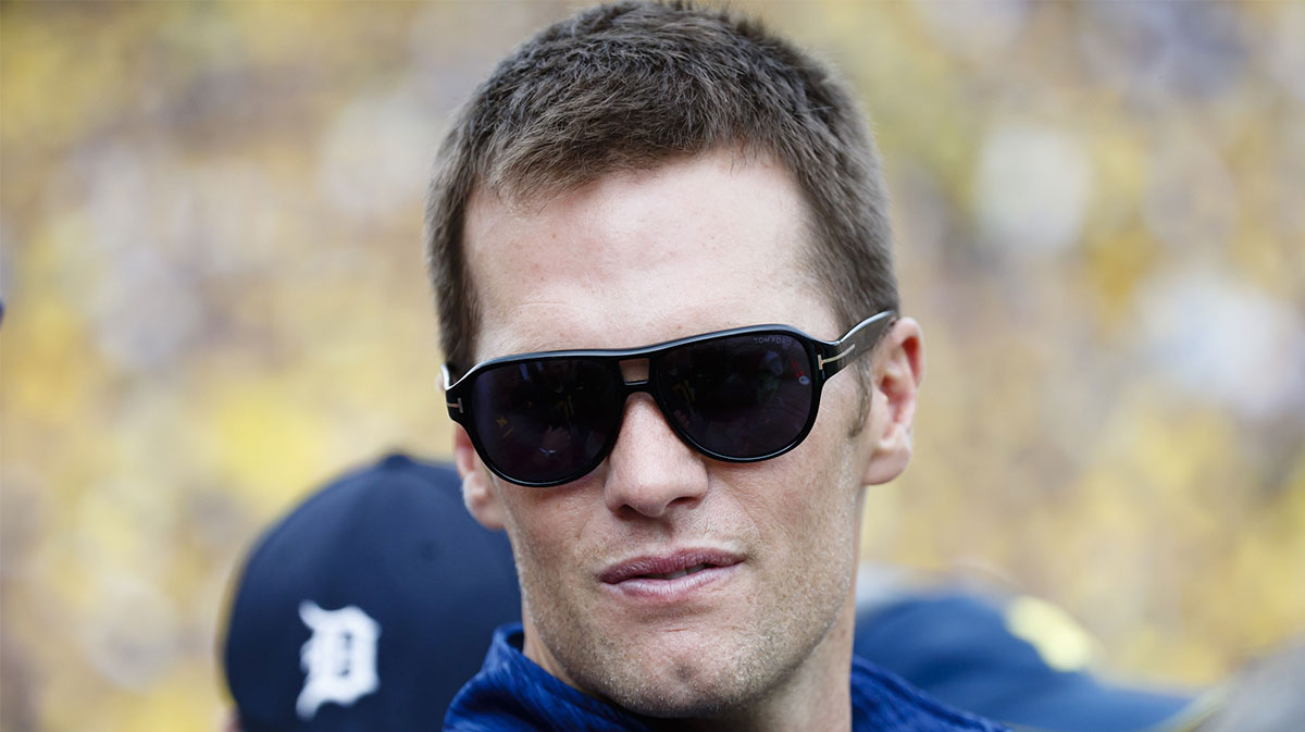 New England Patriots quarterback Tom Brady looks on from the sideline in the first quarter of the game between the Michigan Wolverines and the Colorado Buffaloes at Michigan Stadium