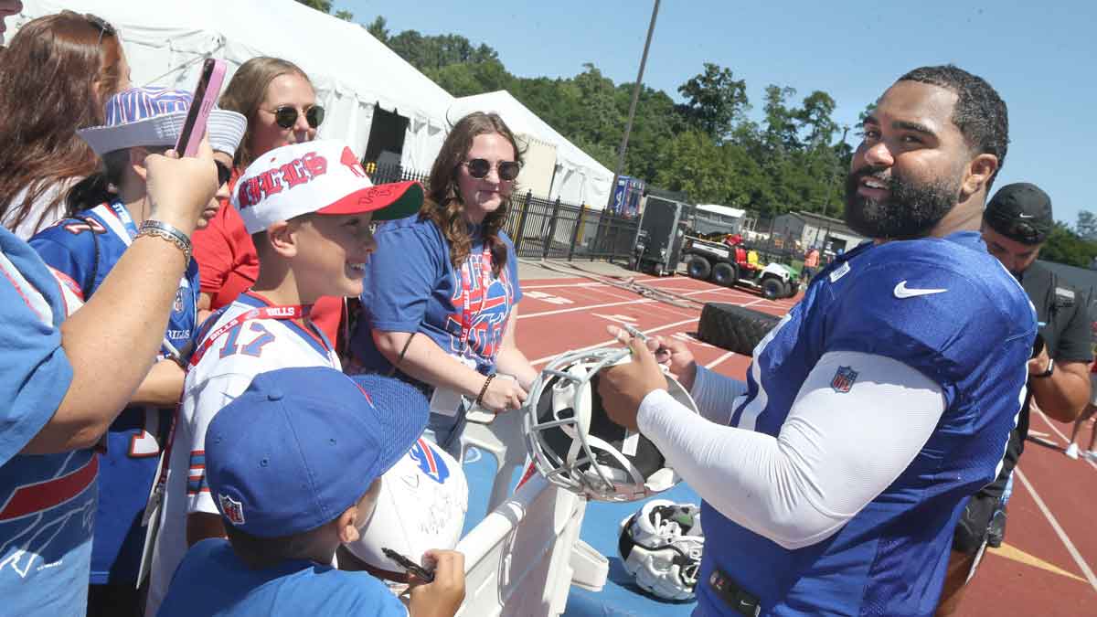 Bills defensive lineman Gable Steveson signs autographs for fans following the Buffalo Bills training camp.