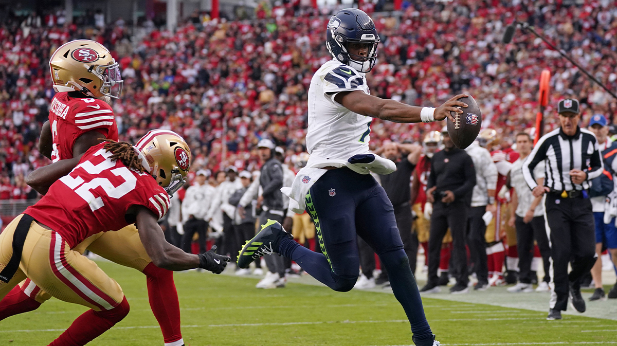 Nov 17, 2024; Santa Clara, California, USA; Seattle Seahawks quarterback Geno Smith (7) scores a rushing touchdown past San Francisco 49ers cornerback Isaac Yiadom (22) to win the game in the fourth quarter at Levi's Stadium.