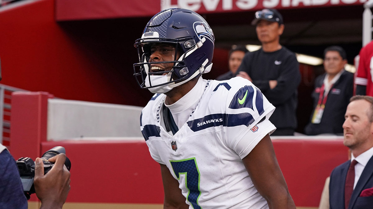 Seattle Seahawks quarterback Geno Smith (7) celebrates after scoring a rushing touchdown past San Francisco 49ers cornerback Isaac Yiadom (22) to win the game in the fourth quarter at Levi's Stadium.