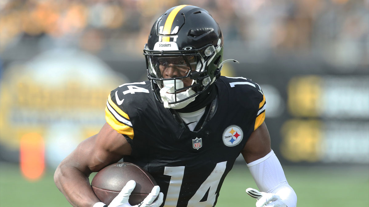 Pittsburgh Steelers wide receiver George Pickens (14) runs after a catch against the Baltimore Ravens during the first quarter at Acrisure Stadium.