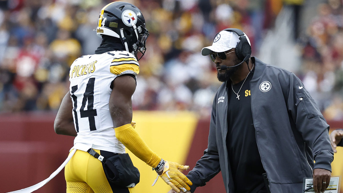 Pittsburgh Steelers head coach Mike Tomlin (R) congratulates Steelers wide receiver George Pickens (14) after a long catch against the Washington Commanders during the second half at Northwest Stadium.