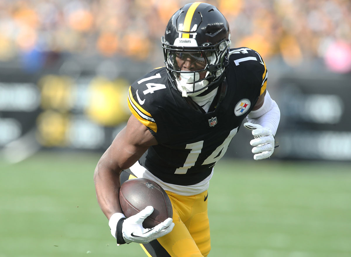 Pittsburgh Steelers wide receiver George Pickens (14) runs after a catch against the Baltimore Ravens during the first quarter at Acrisure Stadium.