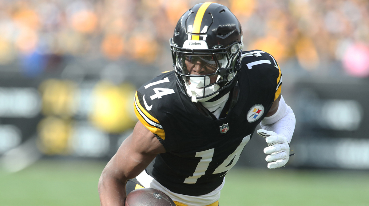 Pittsburgh Steelers wide receiver George Pickens (14) runs after a catch against the Baltimore Ravens during the first quarter at Acrisure Stadium.