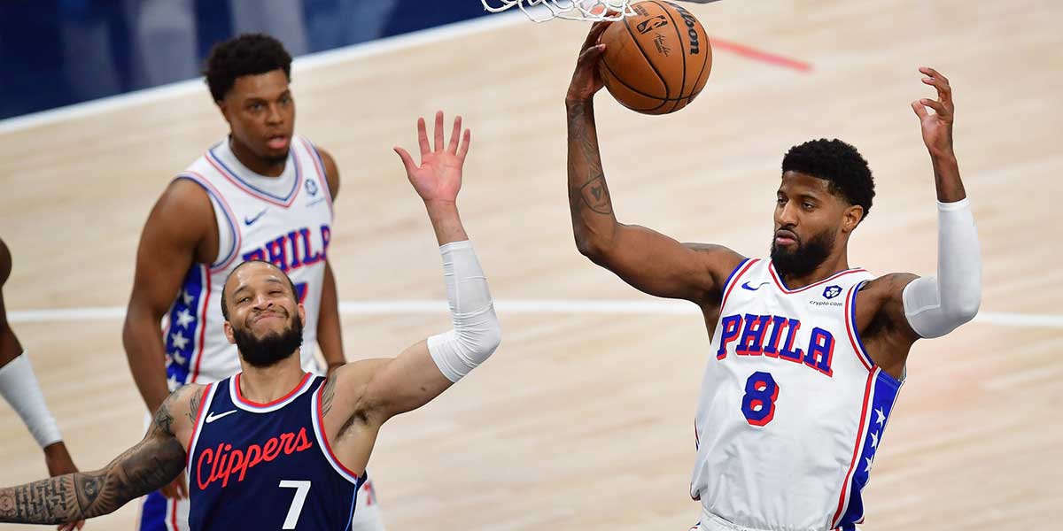 Philadelphia 76ers forward Paul George (8) tackles Los Angeles Clippers guard Amir Coffey (7) during the second half at the Intuit Dome.