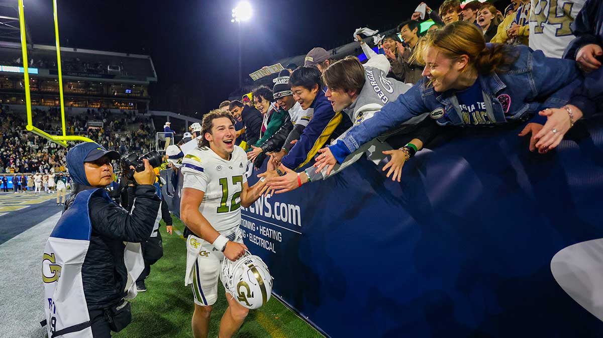 Georgia Tech Yellow Jackets quarterback Aaron Philo (12) celebrates with fans after a victory over North Carolina State Wolfpack at Bobby Dodd Stadium at Hyundai Field.