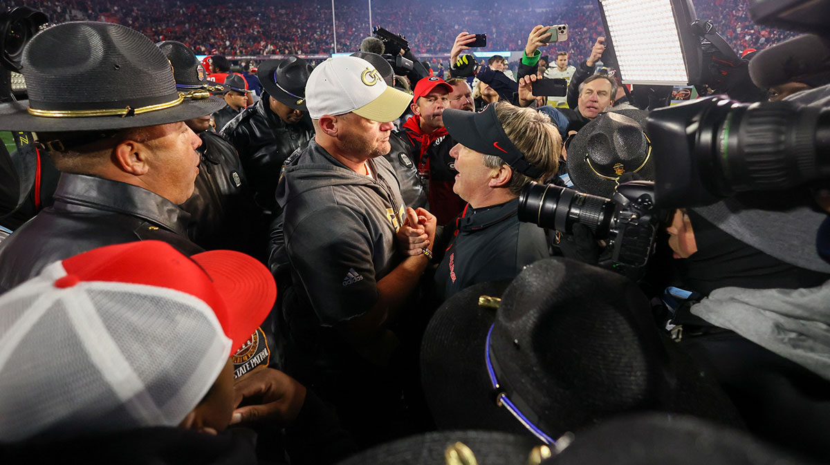 Georgia Tech Yellow Jackets head coach Brent Key talks to Georgia Bulldogs head coach Kirby Smart after an eight overtime game at Sanford Stadium.