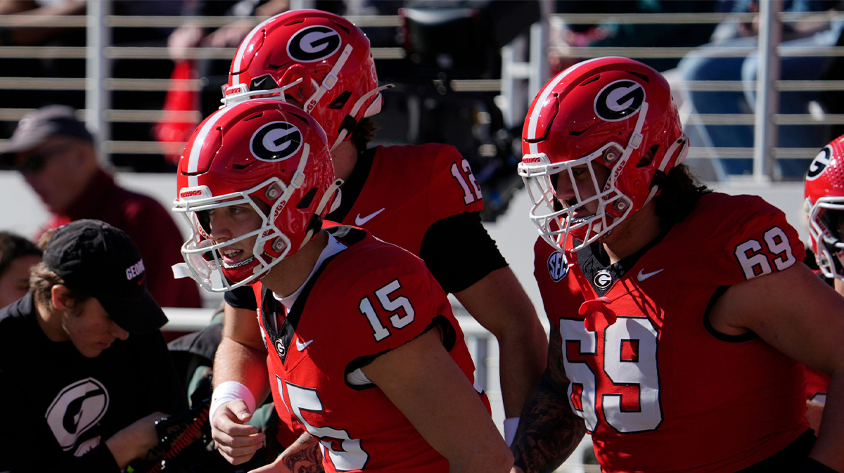 Georgia quarterback Carson Beck (15) takes the field to warm up before the start of a NCAA college football game against Massachusetts in Athens, Ga., on Saturday,