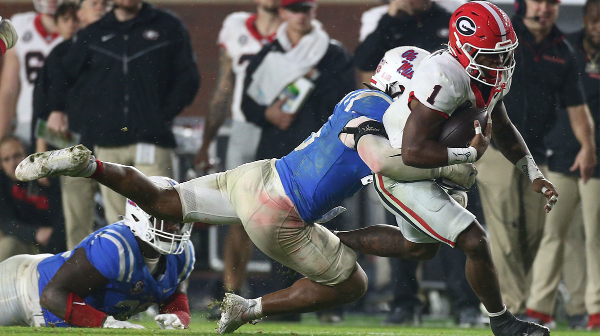 Georgia Bulldogs running back Trevor Etienne (1) runs the ball as Mississippi Rebels linebacker TJ Dottery (6) makes the tackle during the second half at Vaught-Hemingway Stadium