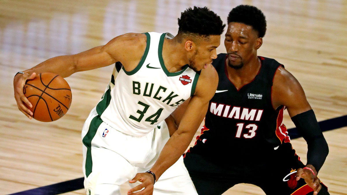 Milwaukee Bucks forward Giannis Antetokounmpo (34) handles the ball against Miami Heat forward Bam Adebayo (13) during the first quarter in game three of the second round of the 2020 NBA Playoffs at ESPN Wide World of Sports Complex. 