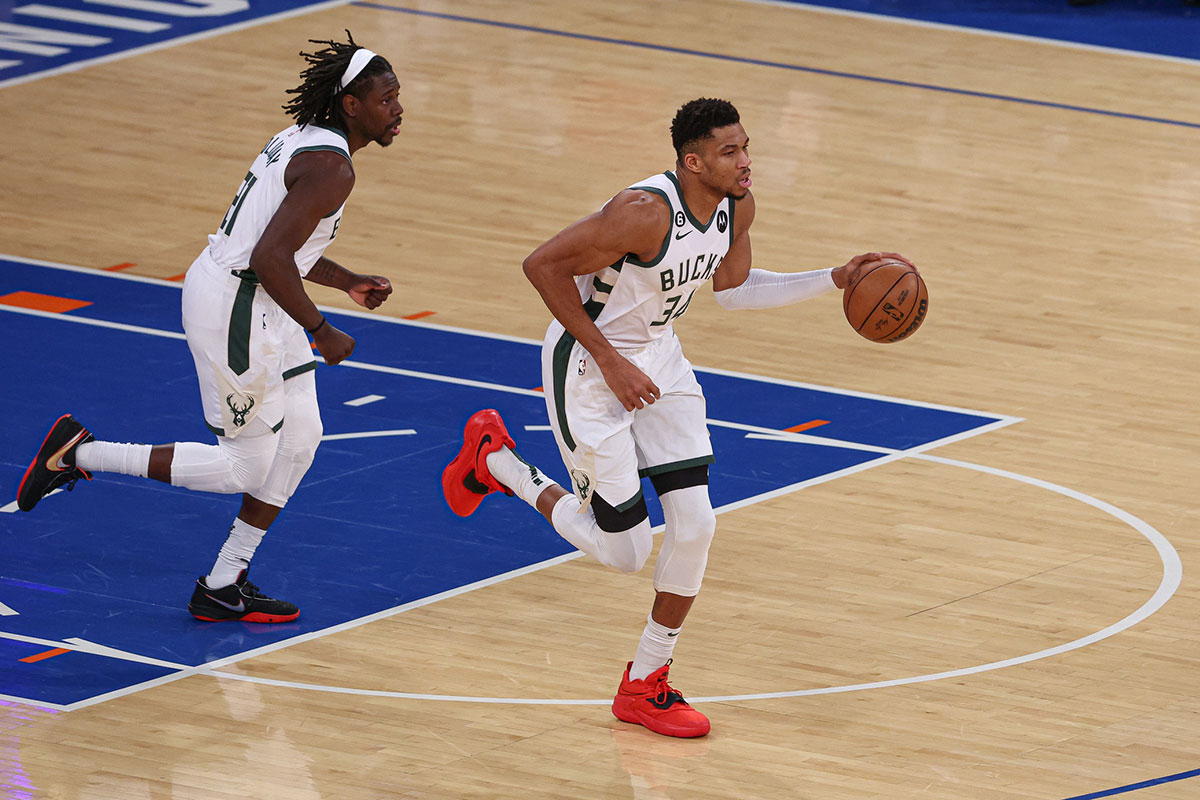 Milvaukee Bucks Next Giannis Antetokounpo (34) Dribble Up Court in front of the Guard Holiday (21) during the first quarter against New York Kneaks in Madison Square Garden.