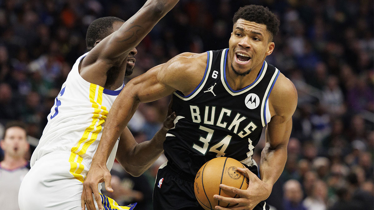 Milwaukee Bucks forward Giannis Antetokounmpo (34) drives for the basket around Golden State Warriors forward Draymond Green (23) during the third quarter at Fiserv Forum. 