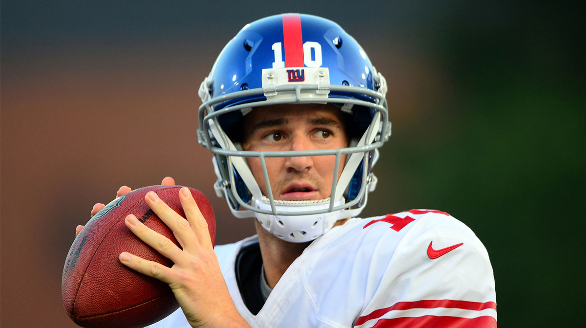 New York Giants quarterback Eli Manning (10) looks to throw a pass during the first quarter of the 2014 Pro Football Hall of Fame game against the Buffalo Bills at Fawcett Stadium