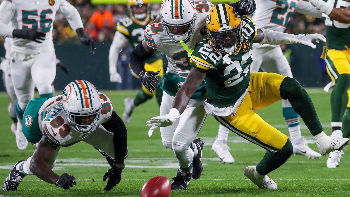 Green Bay Packers cornerback Robert Rochell (22) dives on a muffed punt by Miami Dolphins wide receiver Malik Washington (83) on Thursday, November 28, 2024, at Lambeau Field in Green Bay, Wis. The Packers won the game, 30-17.