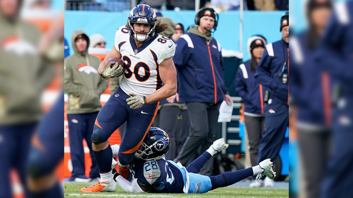 Denver Broncos tight end Greg Dulcich (80) is tackled by Tennessee Titans safety Joshua Kalu (28) during the fourth quarter at Nissan Stadium. 