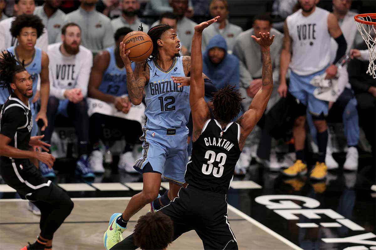 Memphis Grizzlies guard Ja Morant (12) drives to the basket against Brooklyn Nets center Nic Claxton (33) during the fourth quarter at Barclays Center.