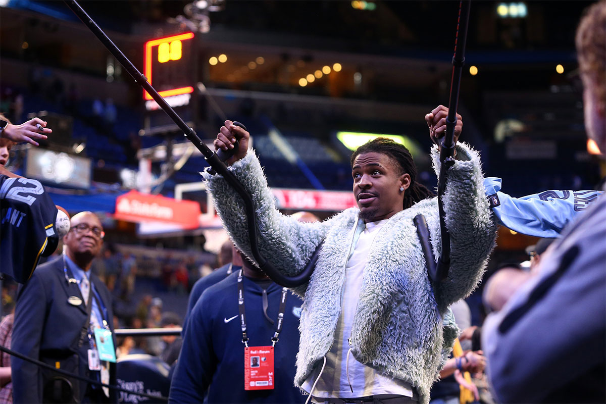 Memphis Grizzlies guard Ja Morant (12) holds up his crutches as he celebrates with fans after a game against the Washington Wizards at FedExForum.