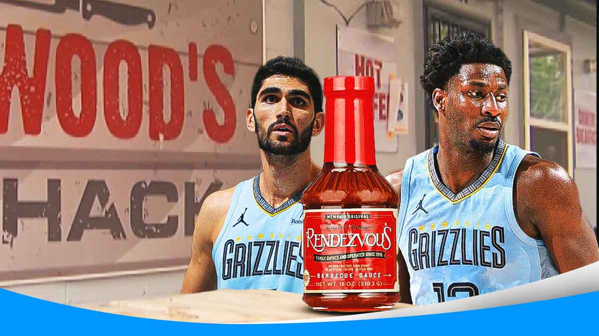 Jaren Jackson Jr. and Santi Aldama sitting at Elwood's Shack in Memphis with a huge bottle of Charley Vergos Rendezvous hot sauce