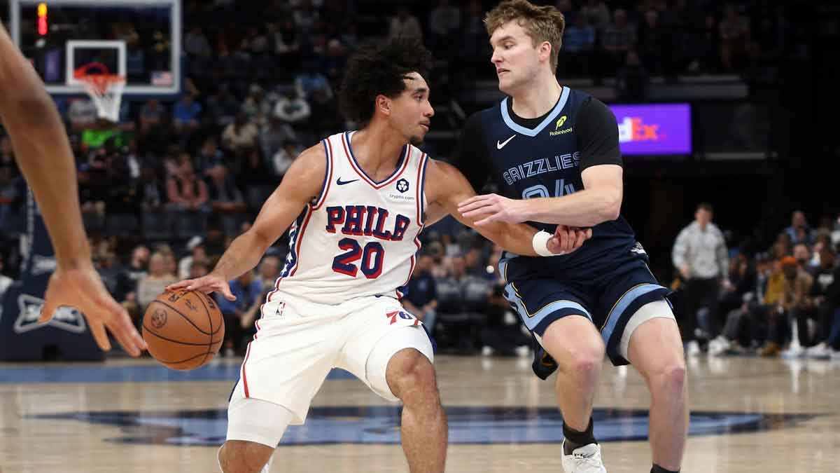 Philadelphia 76ers guard Jared McCain (20) dribbles as Memphis Grizzlies guard Cam Spencer (24) defends during the first half at FedExForum.