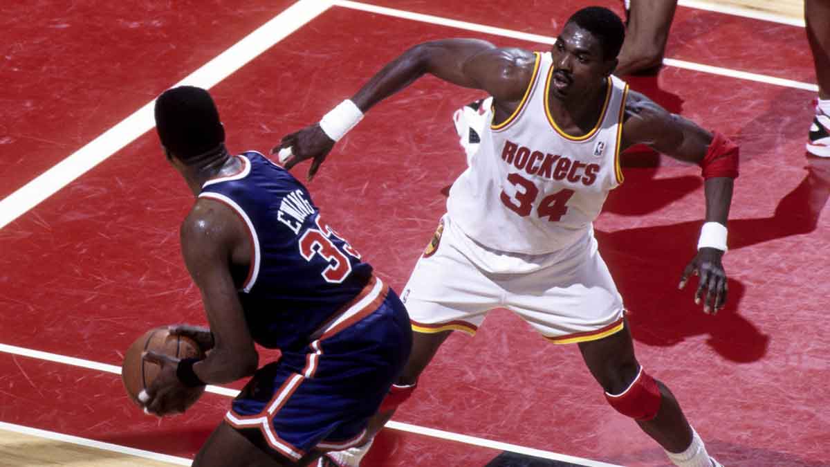 Jun 1994, USA: FILE PHOTO; Houston Rockets center Hakeem Olajuwon (34) defends New York Knicks center Patrick Ewing (33) during the 1994 NBA Finals at the Summit.