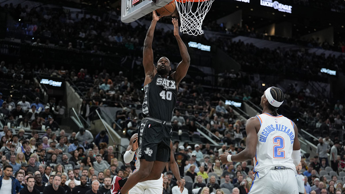 San Antonio Spurs forward Harrison Barnes (40) shoots in front of Oklahoma City Thunder guard Shai Gilgeous-Alexander (2) in the first half at Frost Bank Center. 