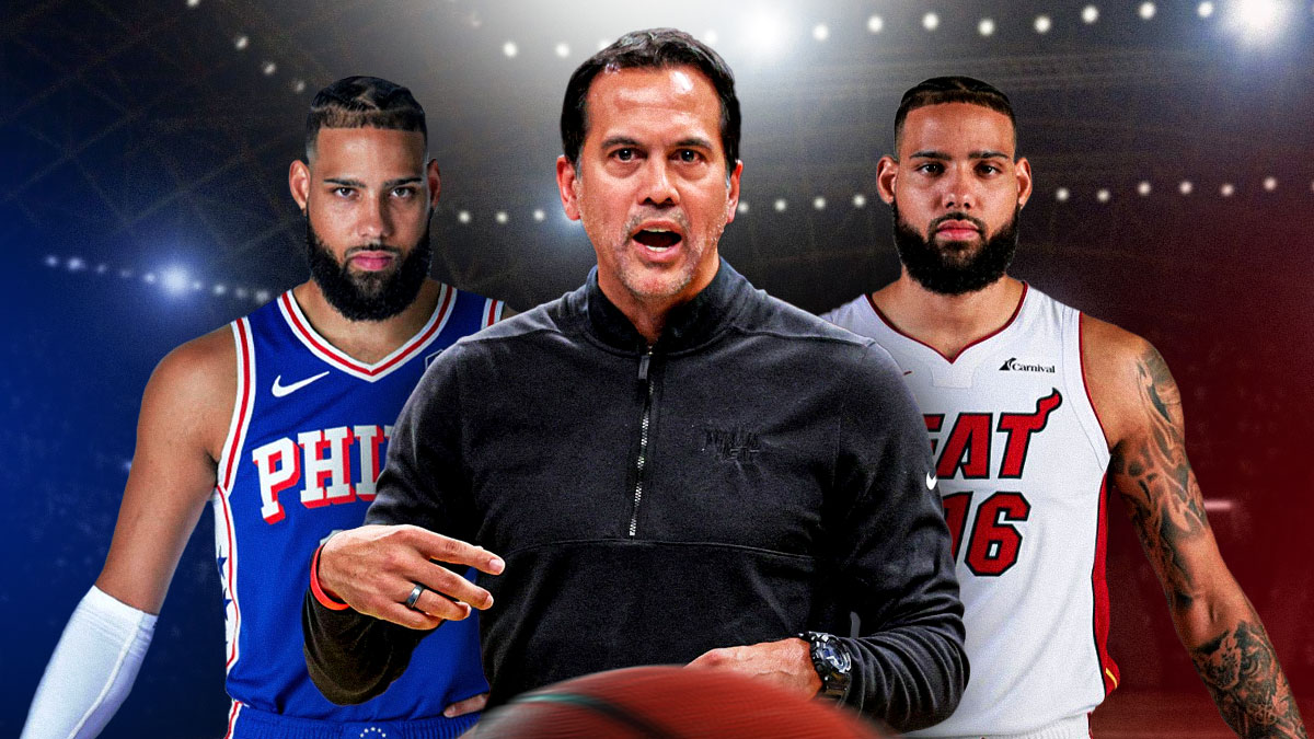 Miami Heat head coach Erik Spoelstra in the middle of Caleb Martin wearing a Heat jersey and another of him on the 76ers on either side. i front of Kaseya Center.