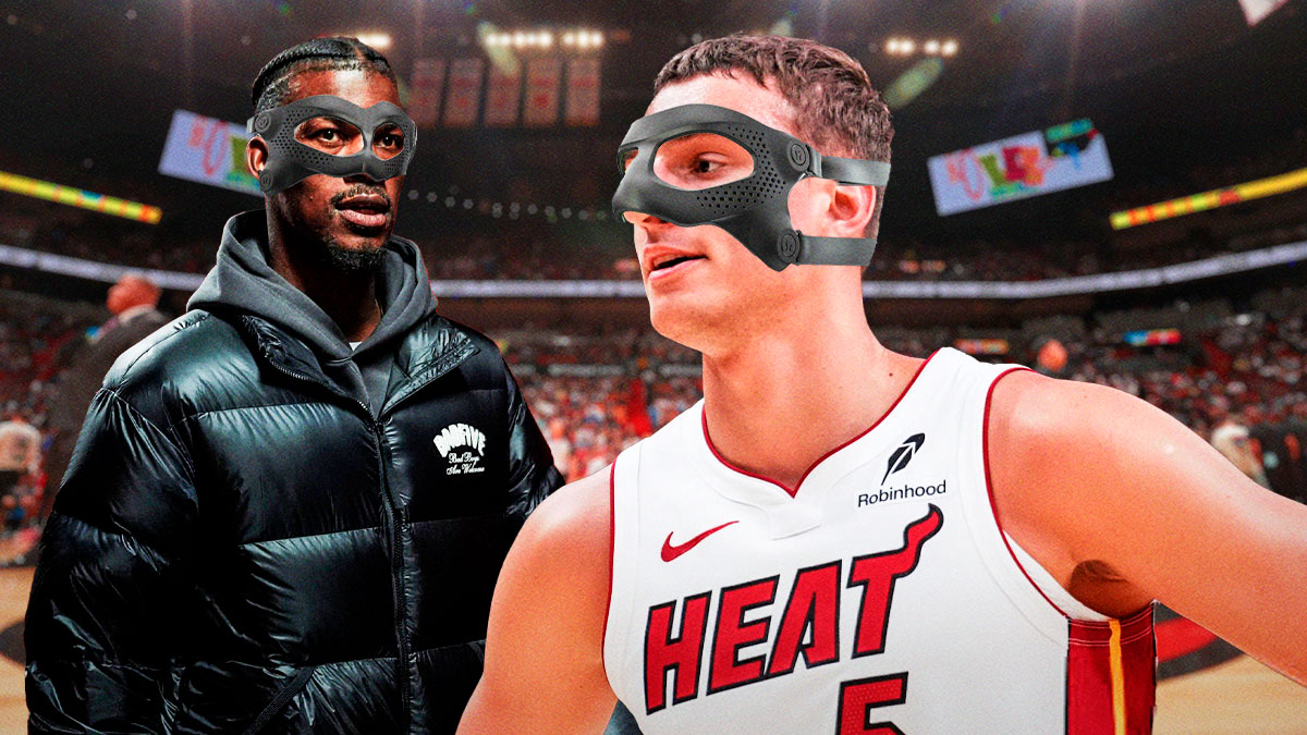 Miami Heat stars Jimmy Butler and Nikola Jovic both with a mask on in front of Kaseya Center.