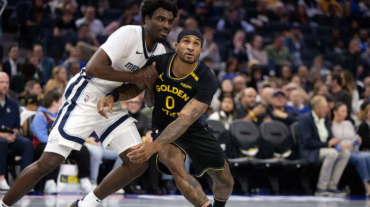 Memphis Grizzlies guard Vince Williams Jr. (left) and Golden State Warriors guard Gary Payton II (0) pursue a rebound during the third quarter at Chase Center.