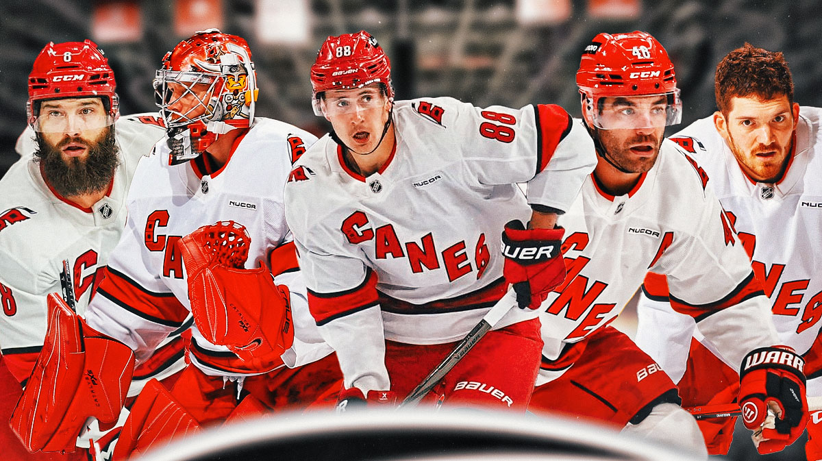 Brent Burns and Frederik Andersen on one side, Martin Necas in middle, Jordan Martinook and Jack Roslovic on other side, Carolina Hurricanes logo, hockey rink in background