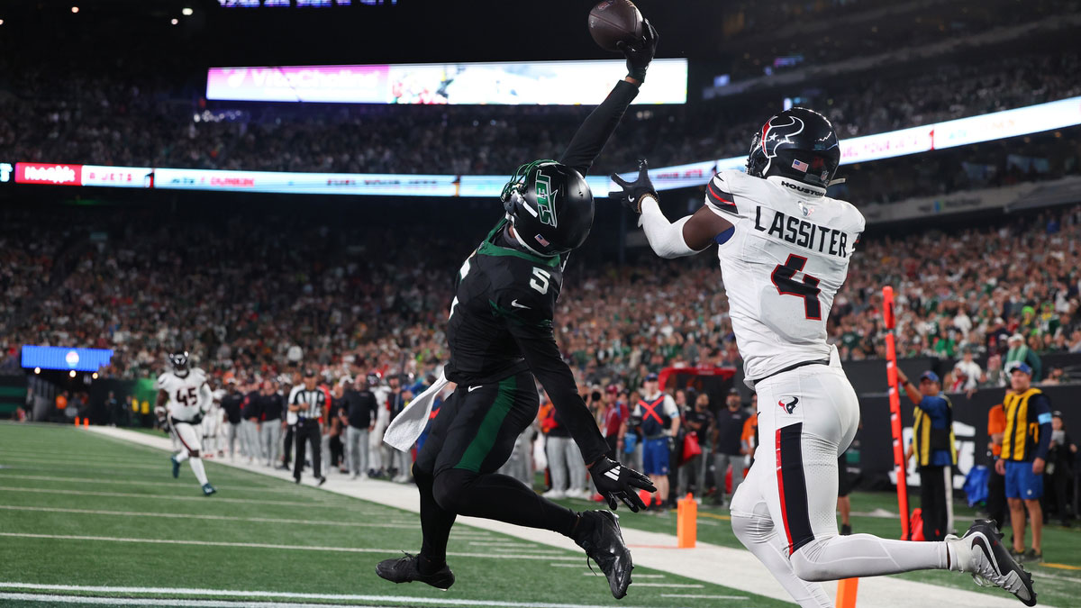 New York Jets wide receiver Garrett Wilson (5) catches a touchdown pass while being defended by Houston Texans cornerback Kamari Lassiter (4) during the second h