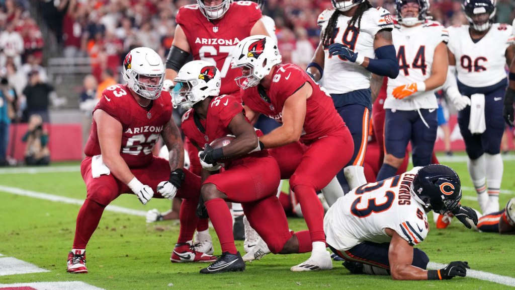 Arizona Cardinals running back Trey Benson (33) celebrates a touchdown against the Chicago Bears during the first half at State Farm Stadium.