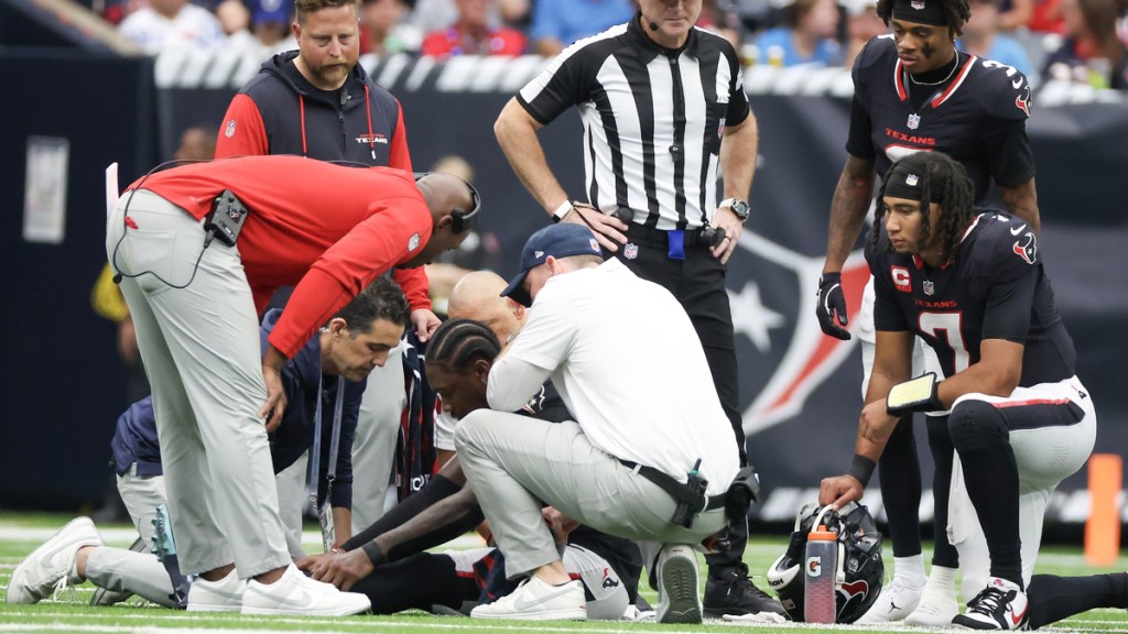 Houston Texans head coach DeMeco Rynas , quarterback C.J. Stroud (7) and wide receiver Tank Dell (3) look down on an injured wide receiver Stefon Diggs (1) against the Indianapolis Colts in the second half at NRG Stadium.