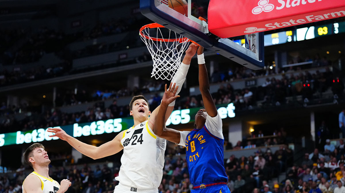 Utah Jazz center Walker Kessler (24) and Denver Nuggets forward Peyton Watson (8) reach for a rebound in the second half at Ball Arena.