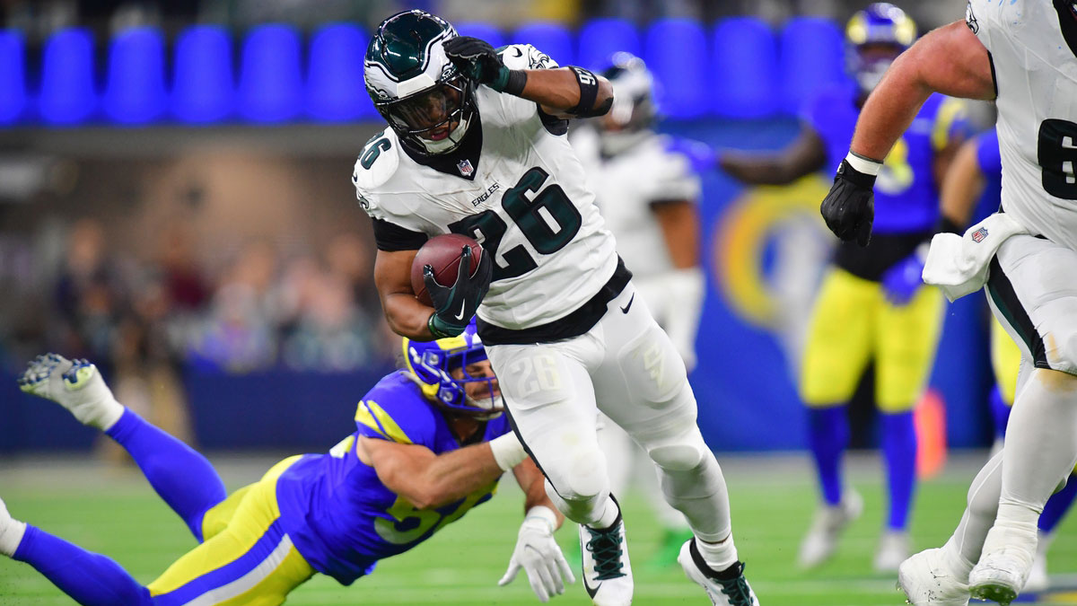 Nov 24, 2024; Inglewood, California, USA; Philadelphia Eagles running back Saquon Barkley (26) runs the ball ahead of Los Angeles Rams linebacker Christian Rozeboom (56) during the second half at SoFi Stadium.