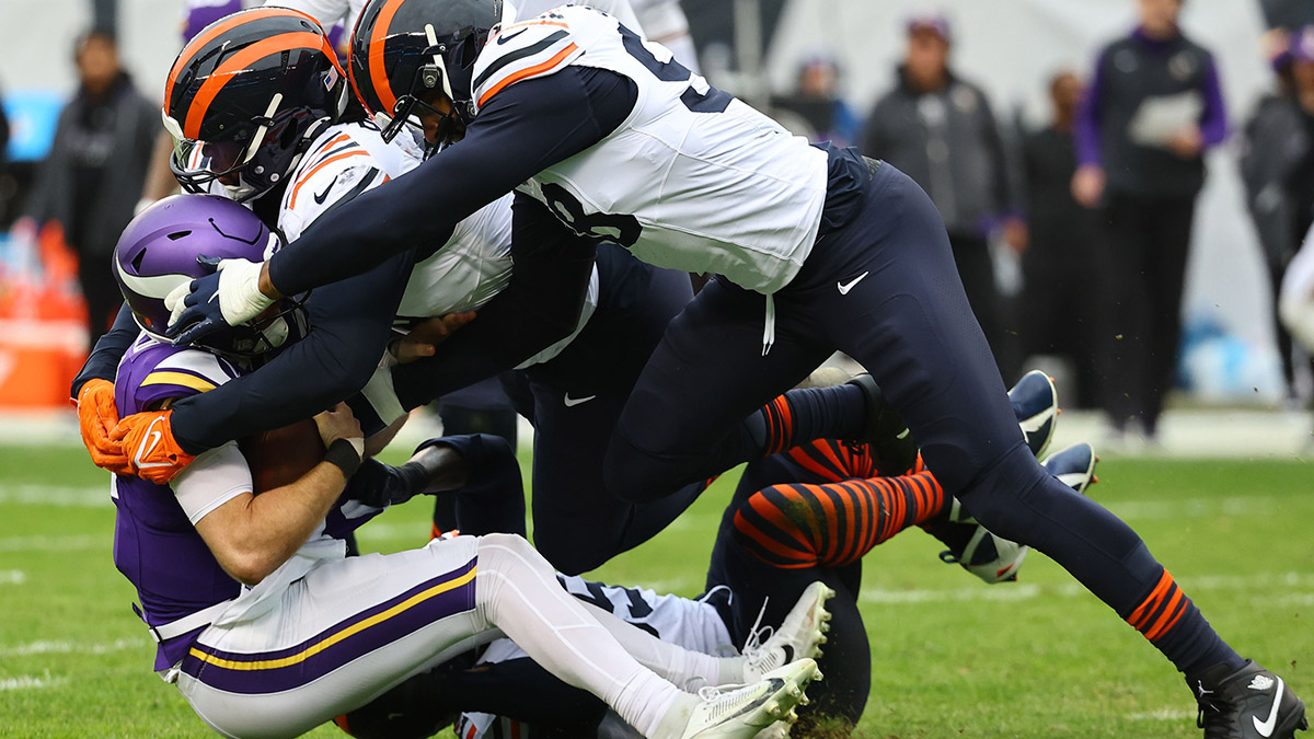 November 24, 2024; Chicago, Illinois, USA; Chicago Bears defensive end Montez Sweat (98) sacks Minnesota Vikings quarterback Sam Darnold (14) in the second half at Soldier Field.