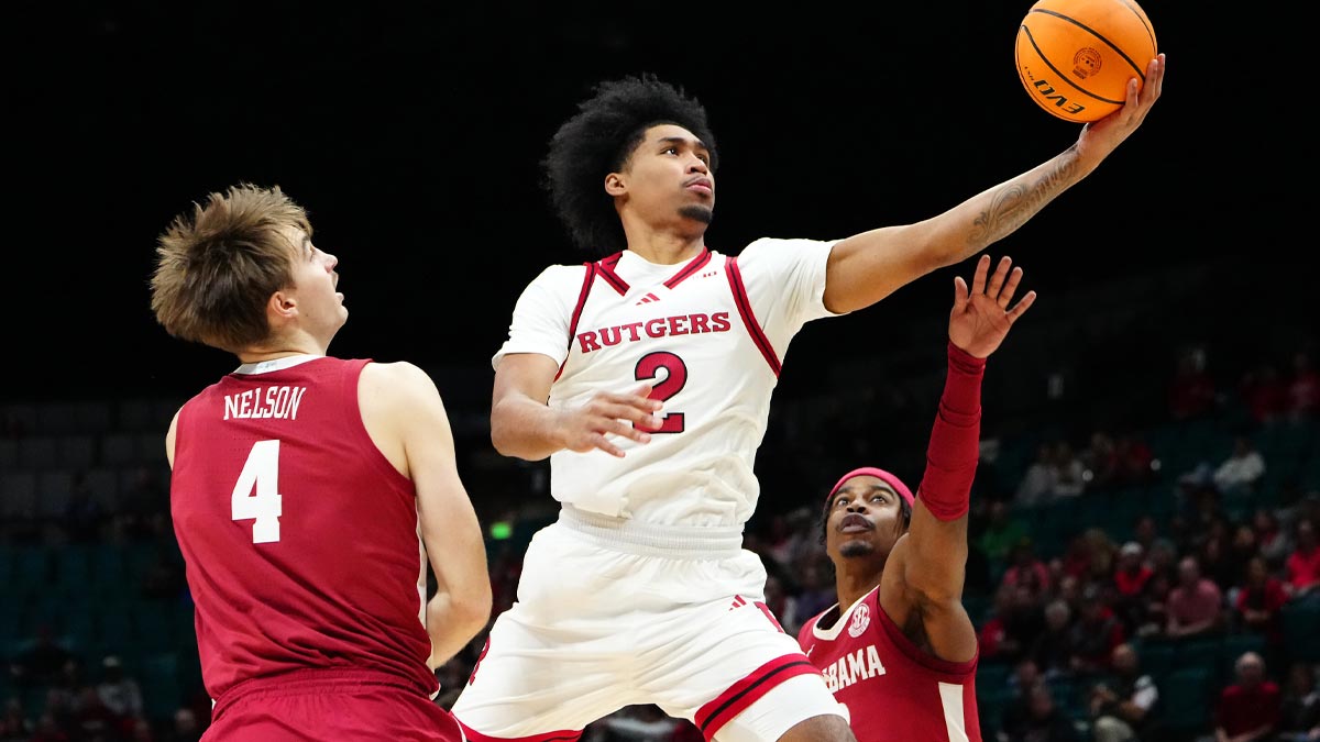 Nov 27, 2024; Las Vegas, Nevada, USA; Rutgers Scarlet Knights guard Dylan Harper (2) shoots between Alabama Crimson Tide forward Grant Nelson (4) and Alabama Crimson Tide forward Jarin Stevenson (15) during the first half at MGM Grand Garden Arena.
