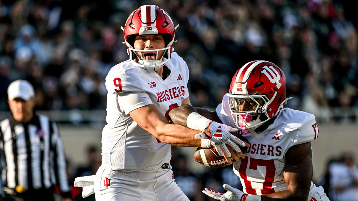 Indiana's Kurtis Rourke, left, hands the ball off to Ty Son Lawton during the second quarter on Saturday, Nov. 2, 2024, at Spartan Stadium in East Lansing.