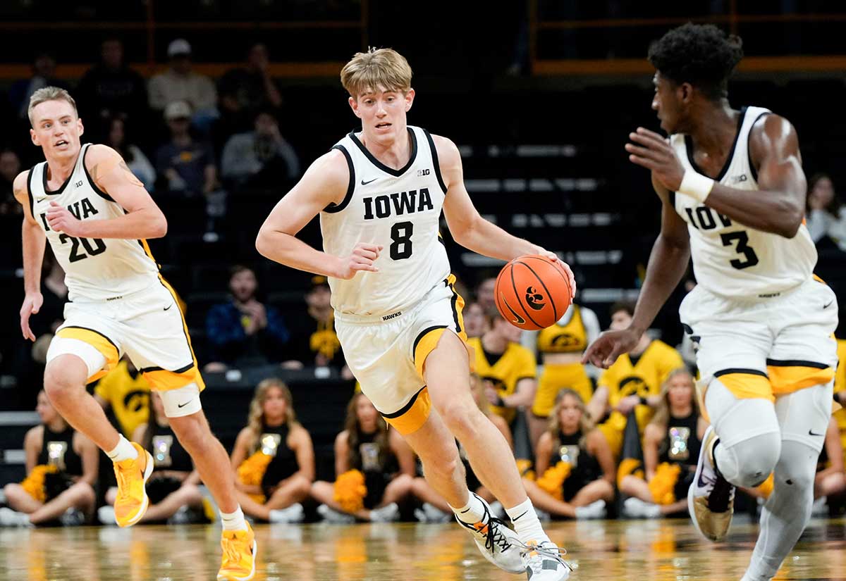 Iowa Hawkeyes forward Cooper Koch (8) dribbles down court against Rider Tuesday, Nov. 19, 2024 at Carver-Hawkeye Arena in Iowa City, Iowa.